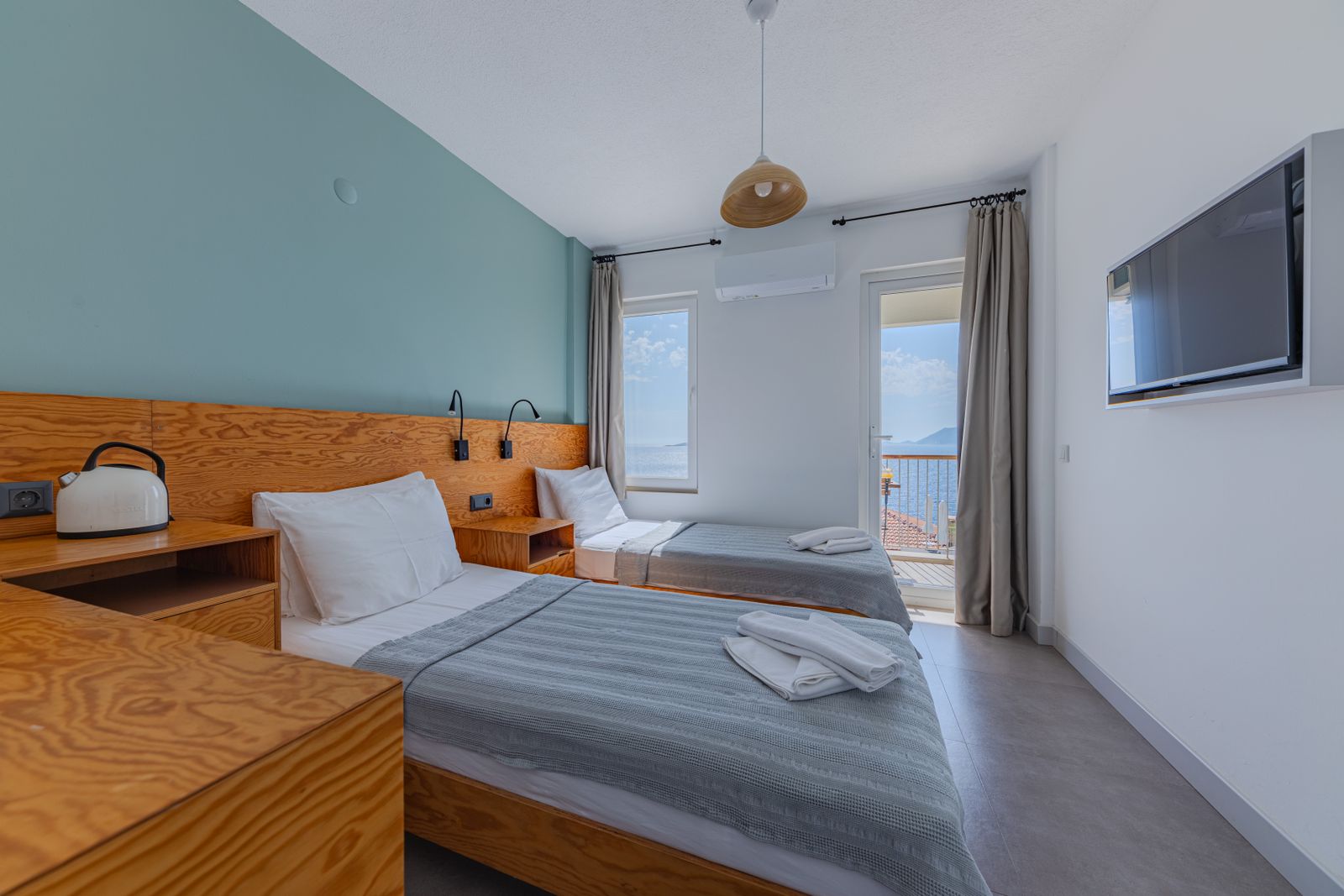 A bright hotel room overlooking the sea